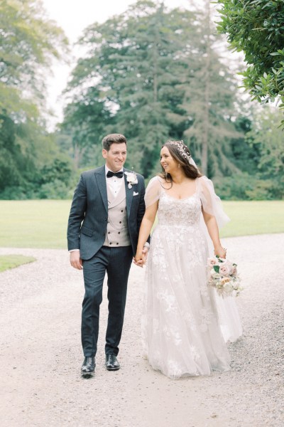 bride and groom walk in the courtyard together