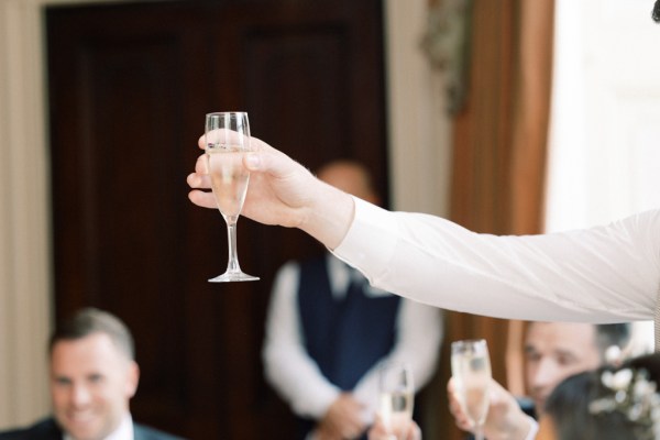 someone cheers with glass of prosecco champagne