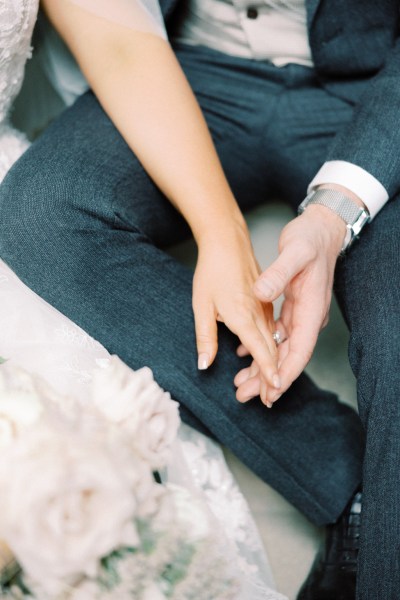 bride and groom cup and hold hands