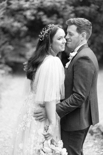 bride and groom embrace b&w image