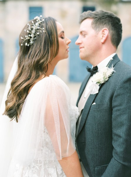 bride and groom face each other close together