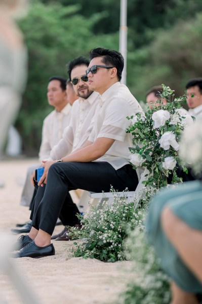 guests wearing sunglasses seated during ceremony