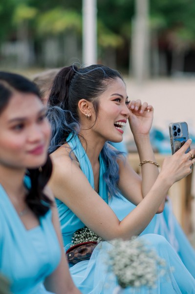 bridesmaids in blue laugh and smile