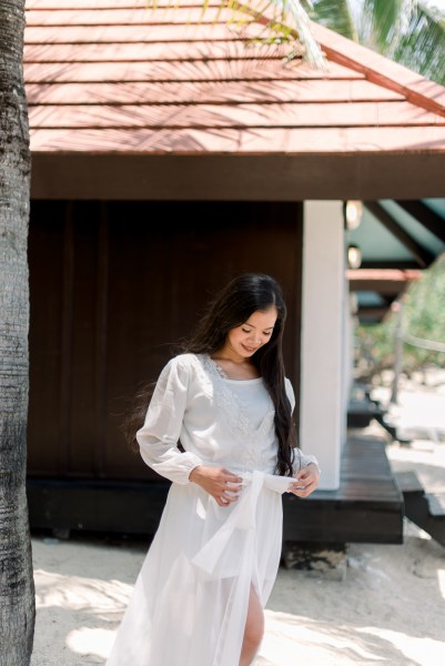 bride walks in white dress outside