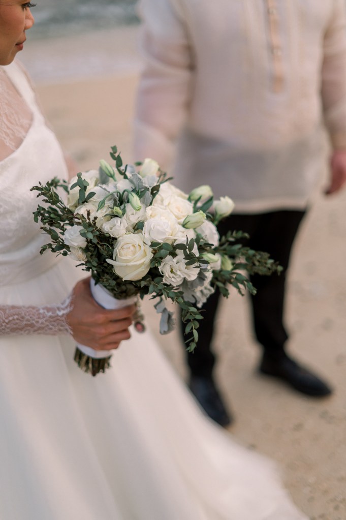 close up of brides bouquet white roses flowers