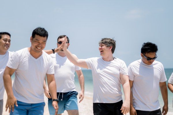 groom and groomsmen on the sandy beach