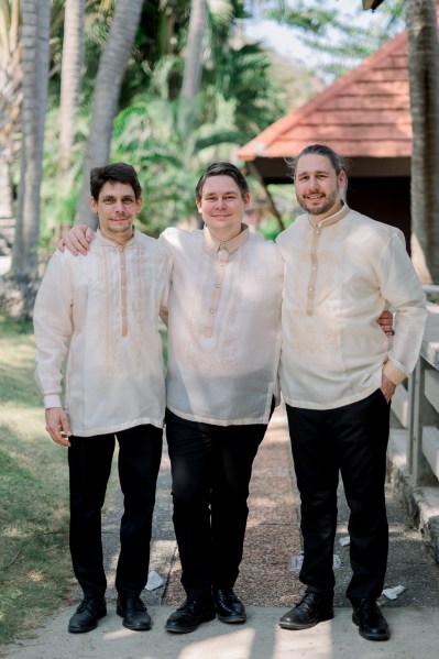 groom posing with groomsmen smiling