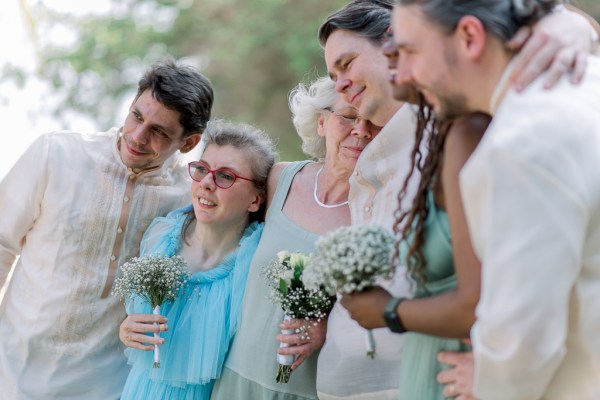 groom mother family members pose for a photo