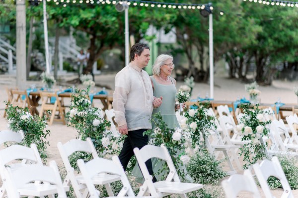 mother walks son groom down the aisle