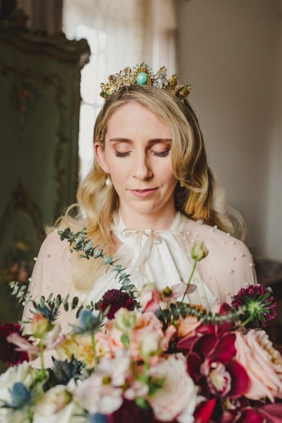 bride looks down at her rose flower bouquet