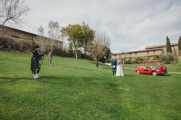 bride and groom from afar golf caddy wedding red car green grass