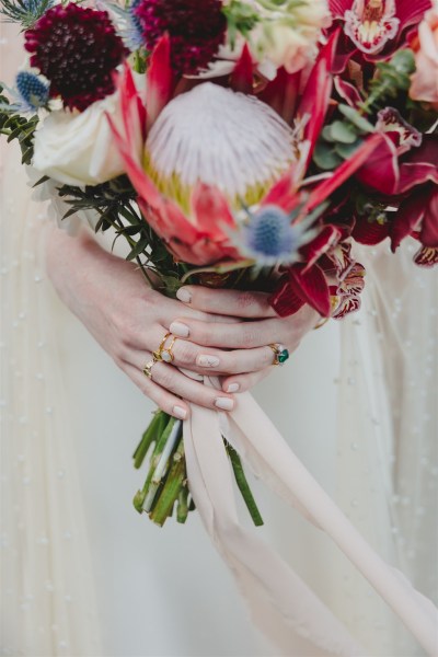 bride holds bouquet of flowers