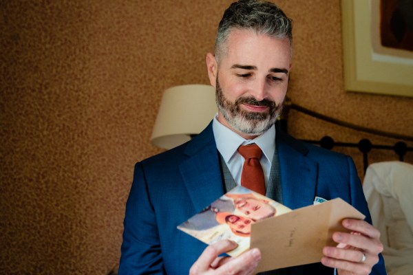 groom opens letter card