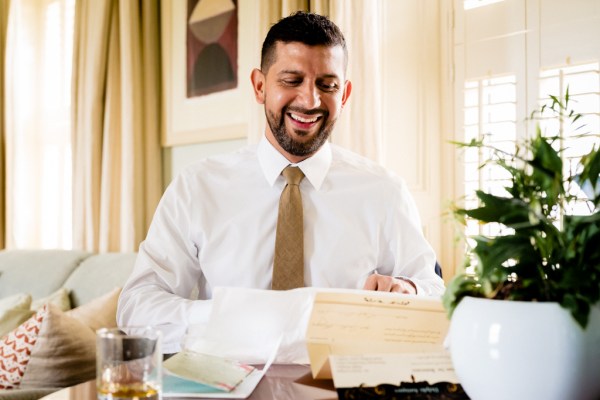 grooms opens letter from groom card he laughs