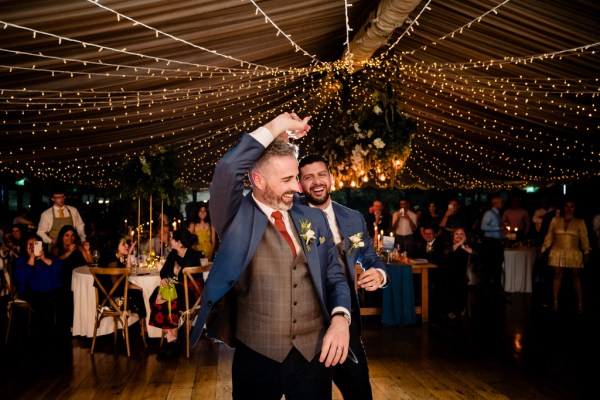 grooms dance on the dancefloor together