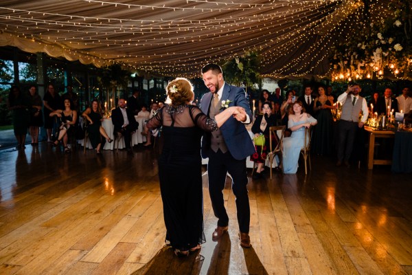 groom dances with mother on the dancefloor