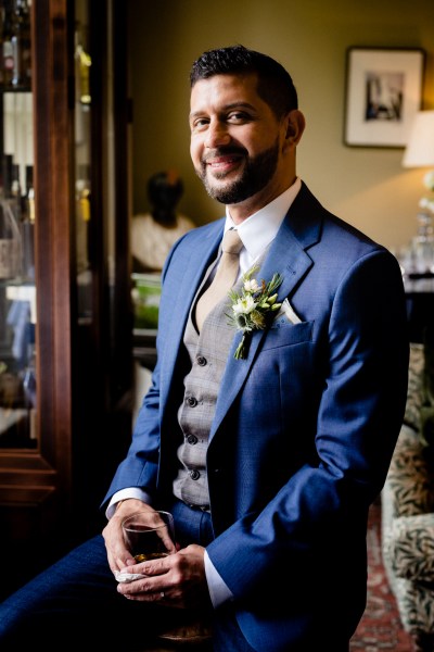 groom in blue suit is wedding ready