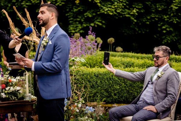 groom stands in front of witness