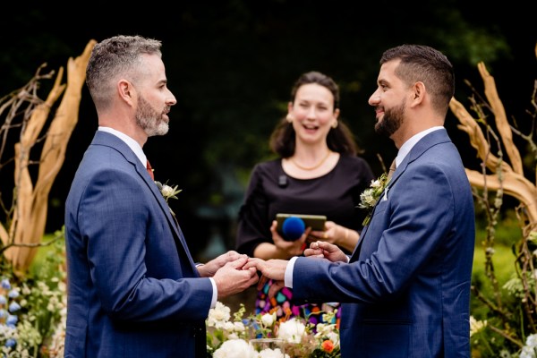 grooms stand at alter with celebrant