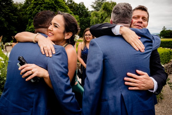 grooms and women hug