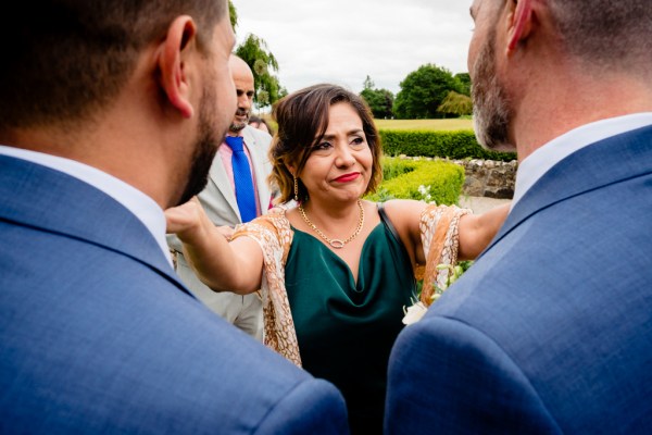 emotional woman with the two grooms