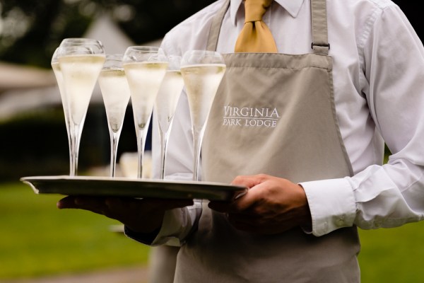 waitress holds tray of champagne prosecco