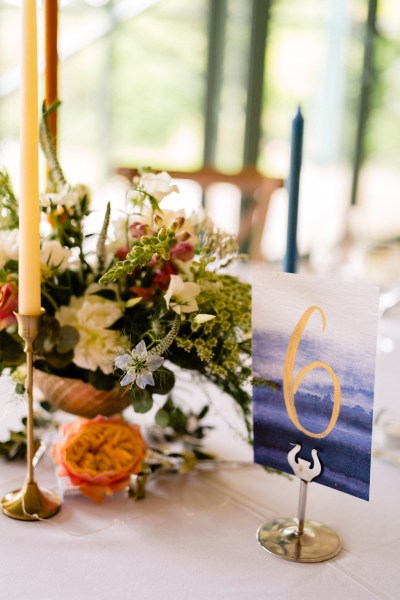 table setting orange candles dining room glasses and flowers table six