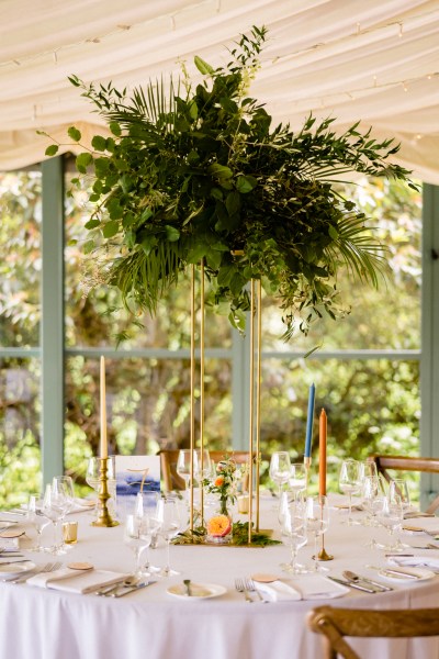 table setting orange candles dining room glasses and flowers