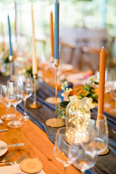 table setting orange candles dining room glasses and flowers