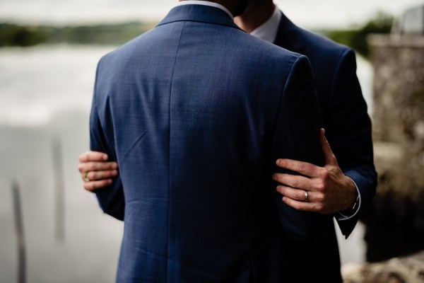 Grooms embrace hug