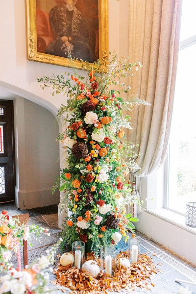 Bed of flowers with pumpkins laid out at the bottom