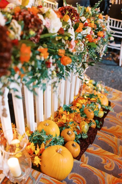 Pumpkins on stairs and orange autumnal flowers