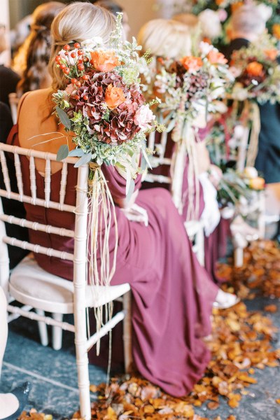 Close up of bridesmaids dress as she sits flowers