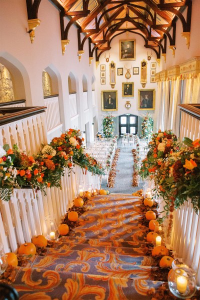 Pumpkins on stairs and orange autumnal flowers