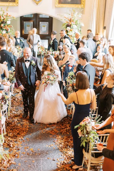 Bride and groom exit ceremonial room guests clapping