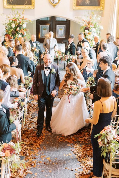 Bride and groom exit ceremonial room guests clapping