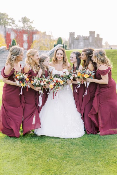 Bride in the middle surrounded by bridesmaids either side