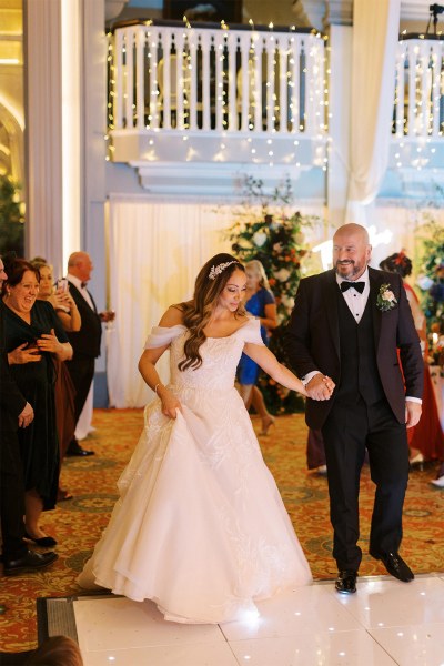 Bride and groom enter ballroom dining room guests are clapping