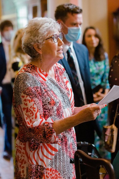 celebrant reads sermon to guests