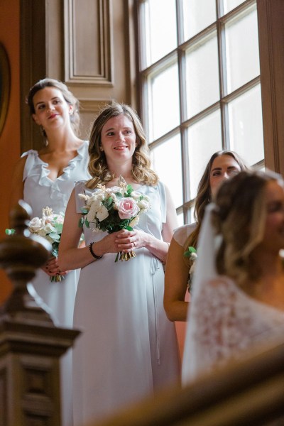 bridesmaids holding bouquet flowers on staircase