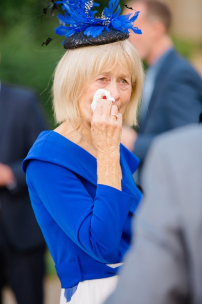 woman/mother in blue dress emotional cries