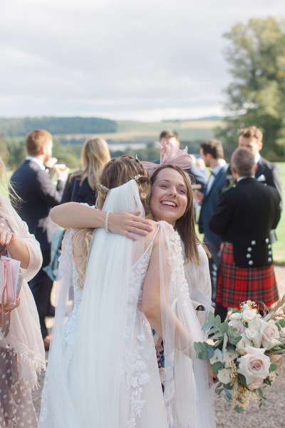 woman hugs bride