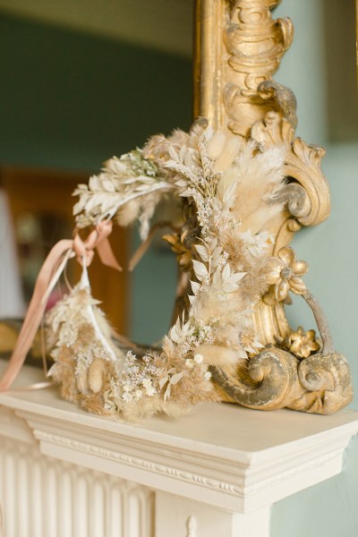 flower wreath placed on fireplace