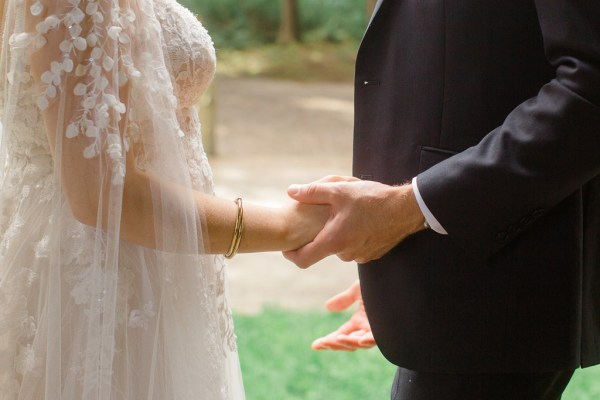 bride and groom holding hands