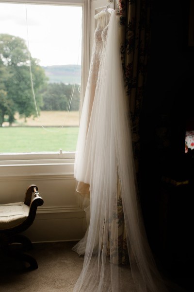 garden view bridal gown dress hanging up at window