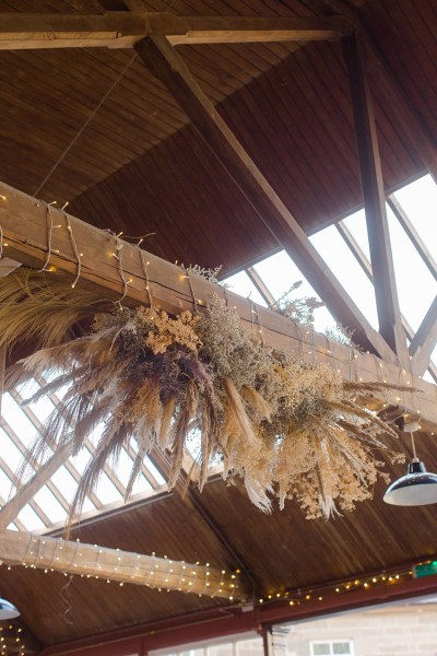 wreath decor hanging above dining room table and chairs