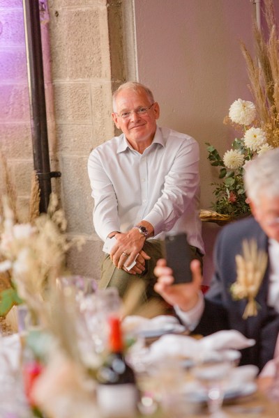 father gives speech at table to couple