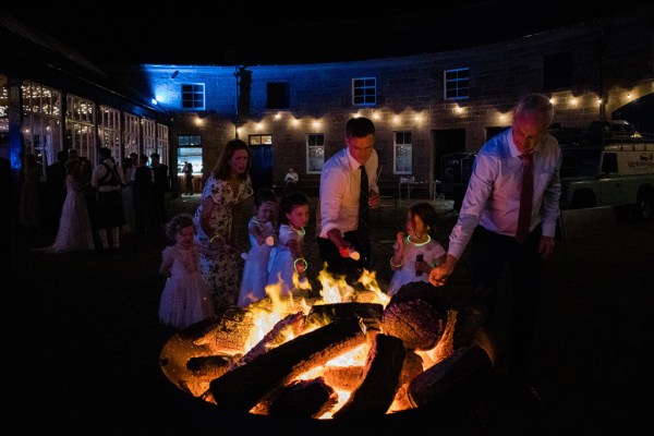 fire bonfire guests getting warm surrounding it