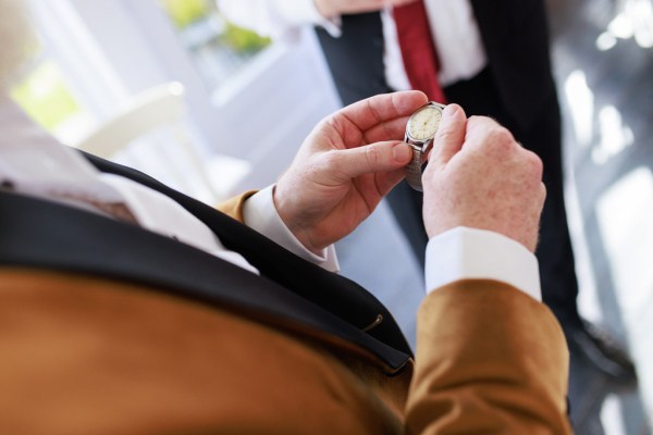 groom puts his wristwatch on