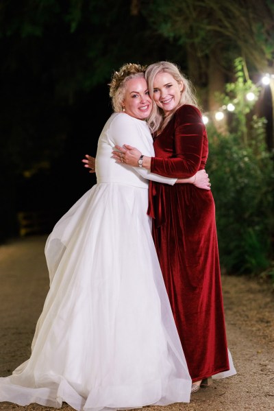 nighttime shot of bride and her bridesmaids wearing silk red dresses